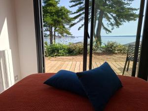 a bedroom with a bed and a view of the ocean at Le chalet Ker Yann Vue mer Locquirec in Locquirec +9 photos