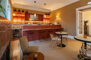 a kitchen with tables and chairs and a counter at Villa Vasco da Gama in Cascais