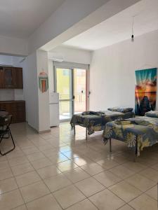a large room with two beds and a kitchen at AS Orikum 2 in Orikum