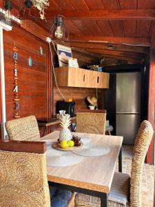 a dining room with a wooden table and chairs at Casa Saga proprietate administrata de o gazda particulara in Mangalia +11 photos