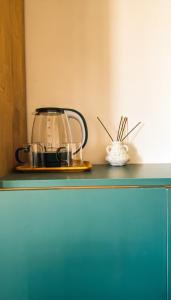 a tea kettle on top of a green cabinet at Bazaleti Hut in Bazalet'i