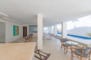 a room with a table and chairs and a pool at Seven Stays Centric West Zayed in Sheikh Zayed