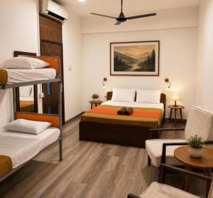 a bedroom with two bunk beds and a couch at CityRest Fort in Colombo