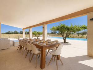 a long wooden table and chairs on a patio at Holiday Home Can Toni by Interhome in Inca