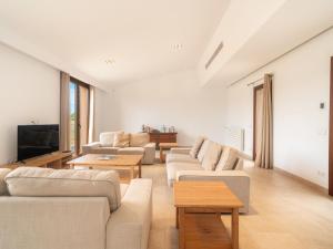 a living room with couches and a flat screen tv at Holiday Home Can Toni by Interhome in Inca