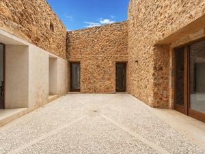 a large brick wall with two doors on it at Holiday Home Can Toni by Interhome in Inca