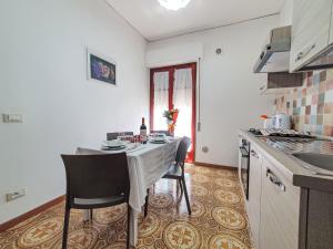 a kitchen with a table and chairs in a kitchen at Holiday Home SinAgo by Interhome in Lascari