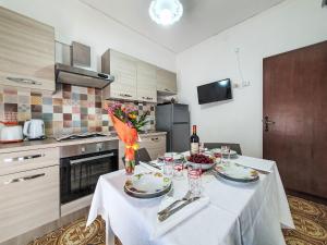 a kitchen with a table with plates and wine glasses at Holiday Home SinAgo by Interhome in Lascari