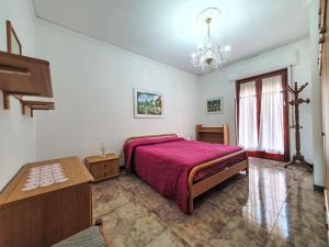 a bedroom with a large bed and a chandelier at Holiday Home SinAgo by Interhome in Lascari +26 photos