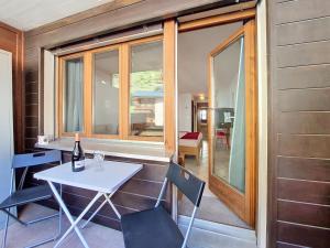 a room with a table and chairs and a window at Apartment Haus Bellevue-7 by Interhome in Zermatt