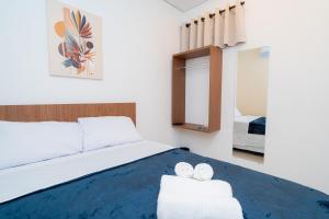 a bedroom with a bed and a table with towels at AIRPORT HOTEL GRU LTDa in Guarulhos +38 photos