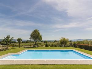 a swimming pool in the middle of a yard with trees at Holiday Home Rosa Tea by Interhome in Bolsena