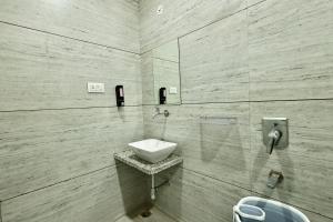a white bathroom with a sink and a toilet at Hotel Maniratna Premium in Indore +93 photos
