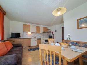 a kitchen and living room with a table and a couch at Apartment Kraftreich Apartments-4 by Interhome in Aschau +57 photos