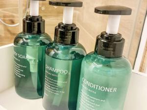 two bottles of shampoo and conditioner sitting on a shelf at Apartment Scheftenau by Interhome in Wattwil