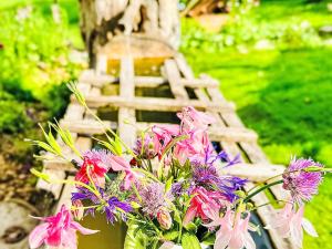 a bouquet of flowers in a vase next to a tower at Apartment Scheftenau by Interhome in Wattwil +29 photos