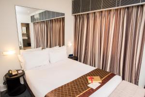 a hotel room with a large bed and a window at Kirketon Hotel Sydney in Sydney +25 photos