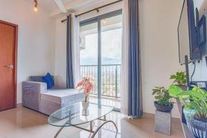 a living room with a glass table and a couch at Skyline Views Pool access Central Location in Yakbedda