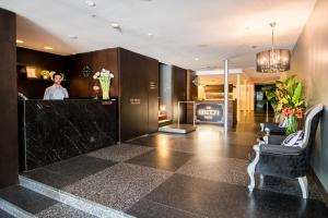 a woman standing at the counter of a salon at Kirketon Hotel Sydney in Sydney