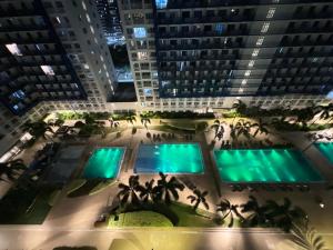 an aerial view of the pool at night at Sea Residences in Manila
