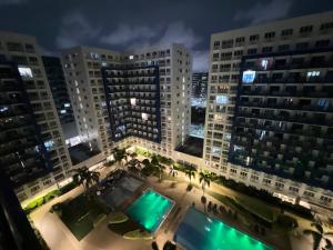 a view of a city at night with tall buildings at Sea Residences in Manila