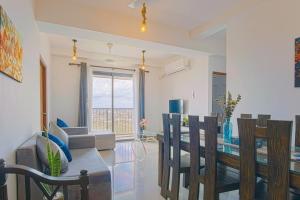 a dining room and living room with a table and chairs at Skyline Views Pool access Central Location in Yakbedda