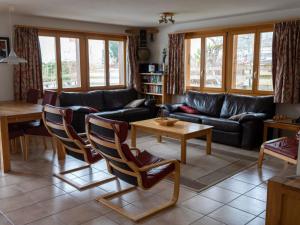 a living room with a couch and a table at Apartment Alpine Retreat by Interhome in Adelboden +6 photos