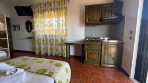 a kitchen with a bed and a sink in a room at Kastro in Skala Potamias