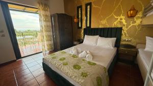 a bedroom with a bed with towels on it at Kastro in Skala Potamias +32 photos