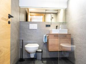 a bathroom with a toilet and a sink at Apartment Miramonte-6 by Interhome in Kappl