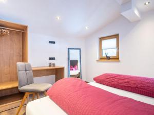 a bedroom with two beds and a desk and a chair at Apartment Miramonte-6 by Interhome in Kappl