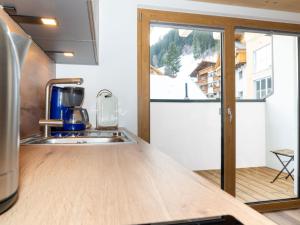 a kitchen with a counter and a sink and a window at Apartment Miramonte-6 by Interhome in Kappl