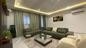 a living room with a couch and a table at Appartement Meublé HS Bonanjo in Douala +2 photos