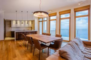 a dining room with a table and chairs at Luxury Seafront Villa Rezevici in Reževići