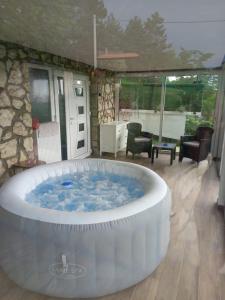 a large hot tub in a room with a room at Vikendica Miličin Konak in Vrdnik +32 photos