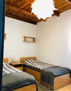 a bedroom with two beds and a chandelier at Ryn Lake Resort 2 in Ryn