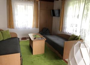 a living room with a couch and a table at Ryn Lake Resort 2 in Ryn