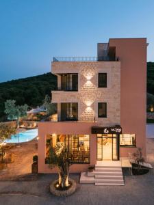 a large building with a pool in front of it at Val D'or Olive Village in Ulcinj