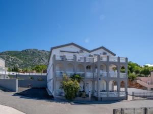 a large white house with a balcony at Apartment Delfin-11 by Interhome in Karlobag +30 photos
