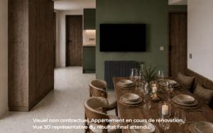 a dining room with a table and chairs and a television at Funiculaire collection in Tignes