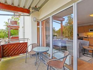 a patio with a table and chairs on a balcony at Apartment Düneneck App-17 by Interhome in Zempin