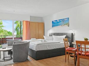 a bedroom with a bed and a table and chairs at Apartment Düneneck App-17 by Interhome in Zempin +28 photos