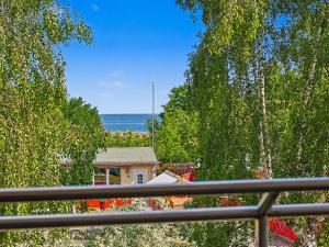 a view of a house and the ocean from a balcony at Apartment Düneneck App-17 by Interhome in Zempin