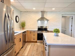 a kitchen with a stainless steel refrigerator and wooden cabinets at White Oak Lodge in Lebanon
