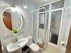 a bathroom with a sink and a toilet and a mirror at Consell Habitaciones in Barcelona +18 photos