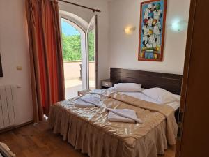 a bedroom with a bed with towels on it at Vila Diamant in Neptun +51 photos