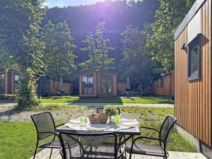 a table with chairs sitting on a patio at Holiday Home Tiny Haus Libelle by Interhome in Riedenburg