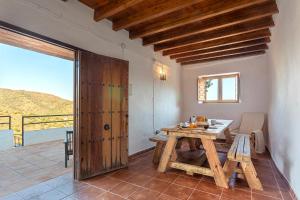 a dining room with a table and a view of the ocean at Campo and relax Málaga country house in Málaga