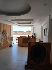 a living room with a table and a counter at Playa Hotel in Dahab
