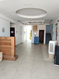 a large room with a white tile floor and a ceiling at Playa Hotel in Dahab